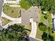 Aerial view of a home featuring a driveway and well-maintained landscaping with lush greenery at 4018 E Bluff Ave, Tampa, FL 33617