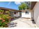 Open back patio with sliding glass doors and a charming brick flower bed at 4018 E Bluff Ave, Tampa, FL 33617