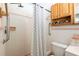 Bathroom featuring a shower, with a patterned shower curtain, a shelf, and sink and toilet at 4018 E Bluff Ave, Tampa, FL 33617