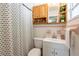Bathroom featuring a shower, with a patterned shower curtain, a shelf, and sink and toilet at 4018 E Bluff Ave, Tampa, FL 33617