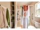 Bathroom with shower and a shelf with towels, plus a patterned shower curtain, and a window at 4018 E Bluff Ave, Tampa, FL 33617