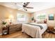 Bedroom featuring a cozy bed, warm lighting, hardwood floors, and stylish decor at 4018 E Bluff Ave, Tampa, FL 33617