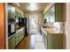 Functional kitchen with modern appliances, granite countertops, and custom green cabinetry at 4018 E Bluff Ave, Tampa, FL 33617
