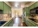 Kitchen area complete with breakfast nook and retro green cabinets at 4018 E Bluff Ave, Tampa, FL 33617