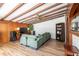Spacious living room featuring wood-beamed ceilings, cozy furniture, and ample natural light at 4018 E Bluff Ave, Tampa, FL 33617