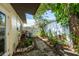 Charming side yard featuring a stone pathway, lush plants, and a privacy fence at 4018 E Bluff Ave, Tampa, FL 33617