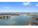 Expansive aerial view of coastal homes surrounded by serene waterways under a blue sky at 459 Haven Point Dr, Treasure Island, FL 33706