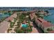 Community aerial view showcasing a pool, tennis courts, and charming residential buildings by the water at 459 Haven Point Dr, Treasure Island, FL 33706
