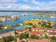 Waterfront community aerial view showcases tennis courts, pool, and beautiful waterways at 459 Haven Point Dr, Treasure Island, FL 33706