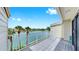 A sunny condo balcony overlooks the waterway and landscaping, providing a tranquil outdoor space at 459 Haven Point Dr, Treasure Island, FL 33706