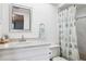 Bright bathroom features a vanity, sink, mirror, and shower-tub combo with a decorative shower curtain at 459 Haven Point Dr, Treasure Island, FL 33706