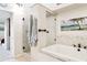 Stylish bathroom showcases glass shower and soaking tub, complemented by beach-themed decor at 459 Haven Point Dr, Treasure Island, FL 33706