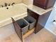 Bathroom cabinet featuring a pull-out double trash can beside a jetted soaking tub at 459 Haven Point Dr, Treasure Island, FL 33706