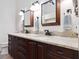 Bathroom features a granite double vanity with dark wood cabinets and modern fixtures at 459 Haven Point Dr, Treasure Island, FL 33706