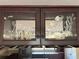Close-up of a cabinet with etched marine life scene on glass panels at 459 Haven Point Dr, Treasure Island, FL 33706