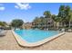 Inviting community pool with lounge chairs, surrounded by tropical trees at 459 Haven Point Dr, Treasure Island, FL 33706