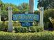 A decorative sign marks the entrance to the Village of Paradise Island community at 459 Haven Point Dr, Treasure Island, FL 33706