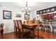 Elegant dining area with hardwood floors, chandelier, wine rack, and access to barstool seating at kitchen at 459 Haven Point Dr, Treasure Island, FL 33706