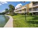 Waterfront condominium complex with manicured landscaping and private patios or balconies at 459 Haven Point Dr, Treasure Island, FL 33706
