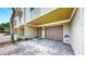 Townhouse front entrance features a garage and entrance steps with brick pavers and coastal design at 459 Haven Point Dr, Treasure Island, FL 33706