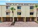 Bright townhouse complex showcasing garages and brick driveways, enhanced by palm trees for classic Florida charm at 459 Haven Point Dr, Treasure Island, FL 33706