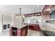 Open kitchen with island, wine rack, granite counters, and stainless appliances at 459 Haven Point Dr, Treasure Island, FL 33706