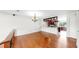 Open-concept living space with hardwood floors, bright lighting, and a view into the kitchen at 459 Haven Point Dr, Treasure Island, FL 33706
