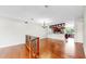Open-concept living room with hardwood floors, chandelier, staircase to kitchen and staircase to bedrooms at 459 Haven Point Dr, Treasure Island, FL 33706
