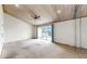 The bright main bedroom is roomy, featuring a wood plank ceiling, neutral carpet, and sliding glass doors to the balcony at 459 Haven Point Dr, Treasure Island, FL 33706
