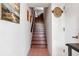 A view of interior stairway featuring wooden steps, white walls and a tiled floor at 459 Haven Point Dr, Treasure Island, FL 33706