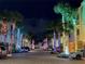 A festive street scene with palm trees adorned with colorful holiday lights at 459 Haven Point Dr, Treasure Island, FL 33706