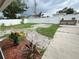 Landscaped backyard with a brick paver path, white vinyl fence, and space for outdoor enjoyment at 4616 5Th N Ave, St Petersburg, FL 33713