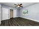Bedroom boasts modern flooring, a ceiling fan, and closet with views from the window at 4616 5Th N Ave, St Petersburg, FL 33713