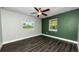 Bright bedroom featuring sleek wood floors, ceiling fan, and dual windows at 4616 5Th N Ave, St Petersburg, FL 33713