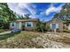 Charming home with light-colored siding, white trim, tidy landscaping, and a small, detached building in the background at 4616 5Th N Ave, St Petersburg, FL 33713