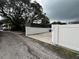 Property exterior with driveway, privacy fence, and mature tree providing shade and curb appeal at 4616 5Th N Ave, St Petersburg, FL 33713