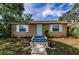 Quaint home with a blue front door, white shutters, and walkway framed by greenery, creating a welcoming entrance at 4616 5Th N Ave, St Petersburg, FL 33713