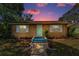 Cozy home featuring a colorful sunset, neat landscaping, and a welcoming walkway leading to the front entrance at 4616 5Th N Ave, St Petersburg, FL 33713