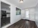 Bright hallway with hardwood floors, leading to a modern kitchen with stainless steel appliances at 4616 5Th N Ave, St Petersburg, FL 33713