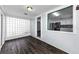 Bright hallway featuring hardwood floors, decorative glass block and a view into a modern kitchen at 4616 5Th N Ave, St Petersburg, FL 33713