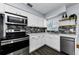 Close up of modern kitchen featuring stainless appliances, mosaic backsplash and quartz countertop at 4616 5Th N Ave, St Petersburg, FL 33713
