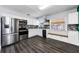 Modern kitchen with stainless steel appliances, sleek countertops, and dark hardwood floors, creating a stylish space at 4616 5Th N Ave, St Petersburg, FL 33713