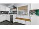 Updated kitchen includes stainless steel appliances, white cabinets, and seating beneath a window at 4616 5Th N Ave, St Petersburg, FL 33713