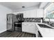 Bright kitchen features stainless steel appliances, white cabinets and modern backsplash and countertops at 4616 5Th N Ave, St Petersburg, FL 33713