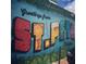 Colorful 'Greetings from St. Pete, Florida' mural on a building with a car partially visible at 4616 5Th N Ave, St Petersburg, FL 33713