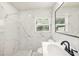 Updated bathroom featuring marble tile and modern fixtures at 4816 N Fremont Ave, Tampa, FL 33603