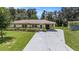 Charming single story home with a well-manicured lawn, mature landscaping and a long concrete driveway at 4816 N Fremont Ave, Tampa, FL 33603