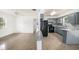 Open-concept kitchen with a breakfast bar, light-blue cabinetry, and terrazzo floors at 4816 N Fremont Ave, Tampa, FL 33603
