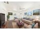 Bright living room featuring neutral furnishings, ceiling fan, and natural light from the windows at 4816 N Fremont Ave, Tampa, FL 33603