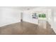 Bright living space featuring a terrazzo floor and open access to the kitchen at 4816 N Fremont Ave, Tampa, FL 33603